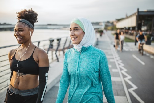 Two women walking side by side.