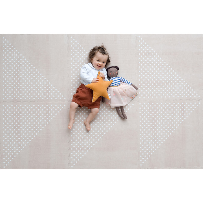 A baby laying on a chic minimalist playmat.