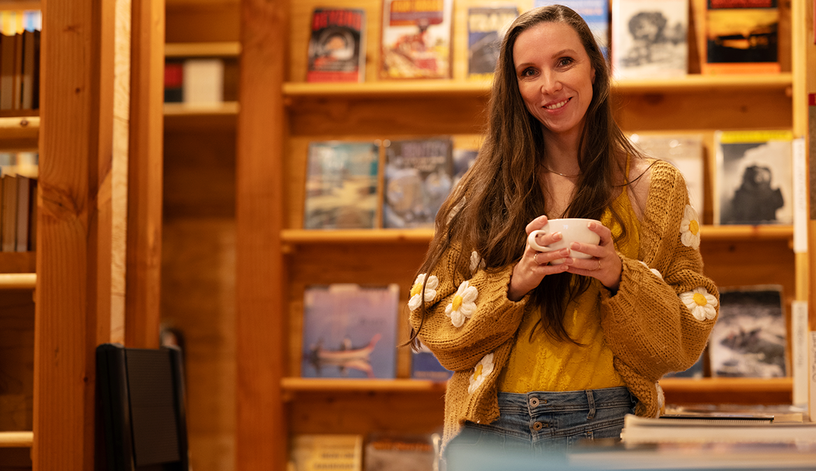 woman with chronic eczema drinking coffee in a bookstore