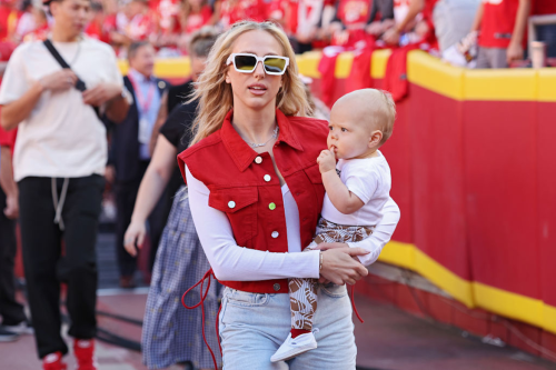 Brittany Mahomes, who recently shared about a back injury caused by a weak pelvic floor, carrying her baby at a Chiefs game