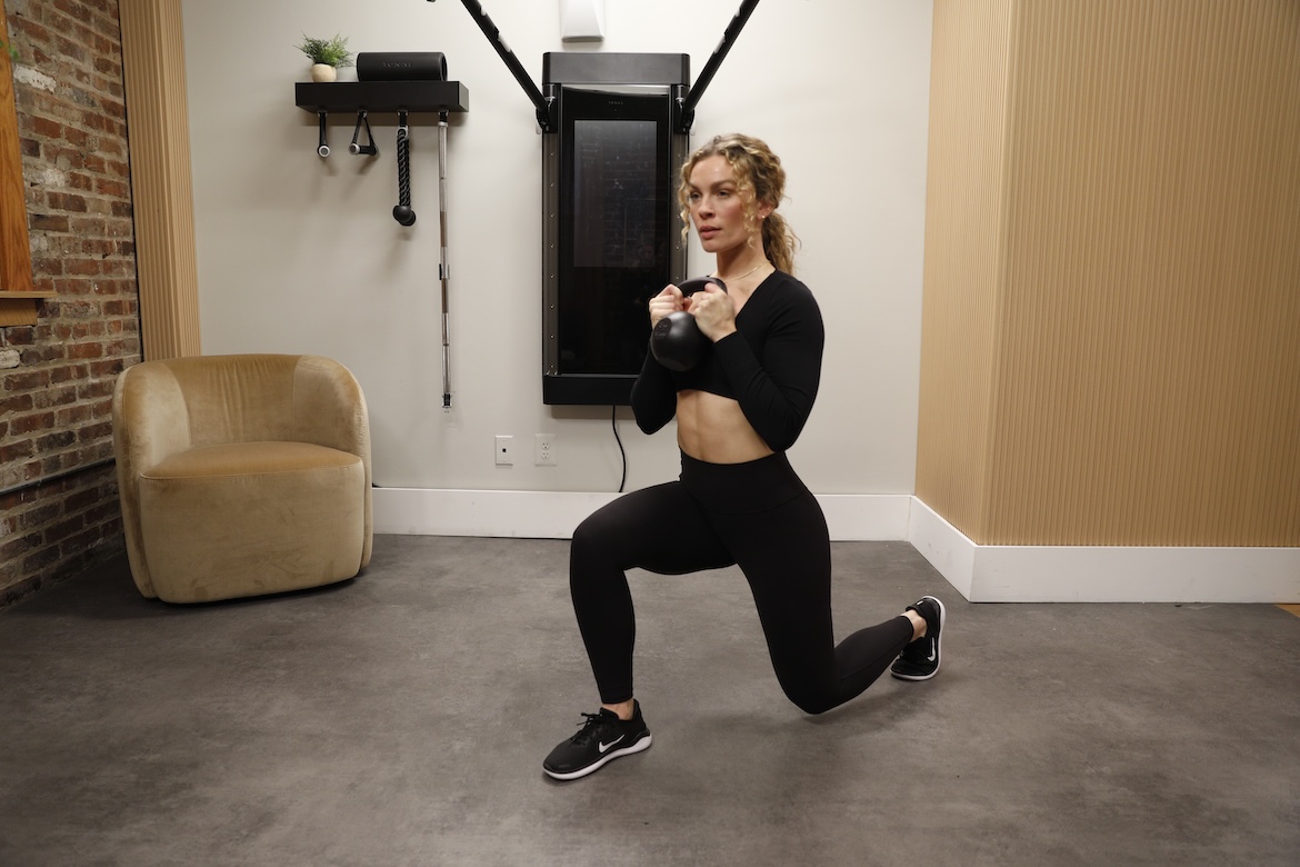 Personal trainer demonstrating goblet reverse lunge