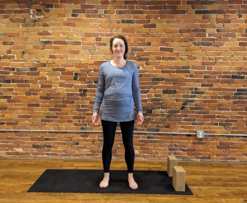 Pregnant woman doing mountain pose yoga