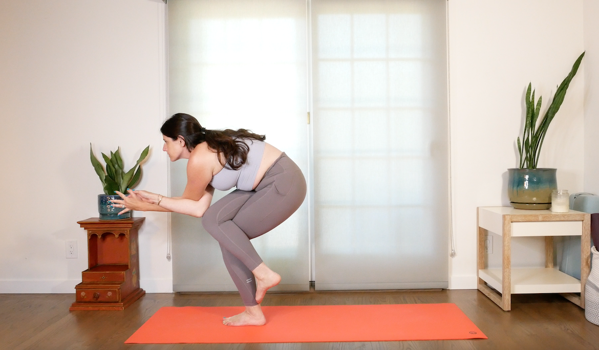 yoga teacher demonstrates how to perform the nesting eagle pose in yoga 
