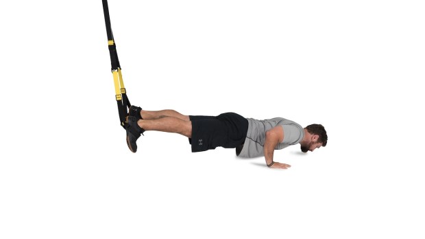Person demonstrating TRX atomic pushups as part of a TRX workout