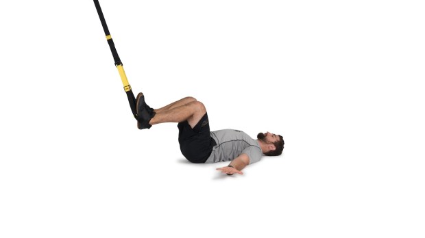 Person demonstrating TRX hamstring curl as part of a TRX workout