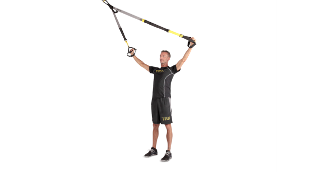 A person demonstrating the TRX Y-Fly as part of a TRX workout.