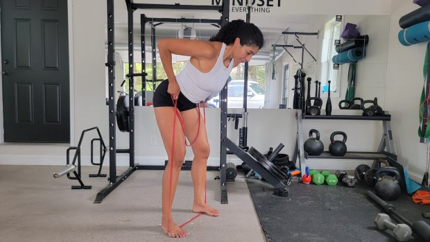 Personal trainer demonstrating banded bent-over row with bilateral stance