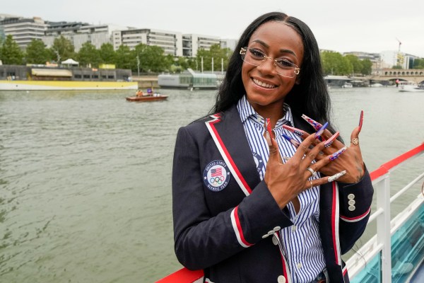 Sha'Carri Richardson poses for a photo while riding with teammates on a boat with teammates along the Seine River during the Opening Ceremony of the Olympic Games Paris 2024 on July 26, 2024 in Paris, France. 