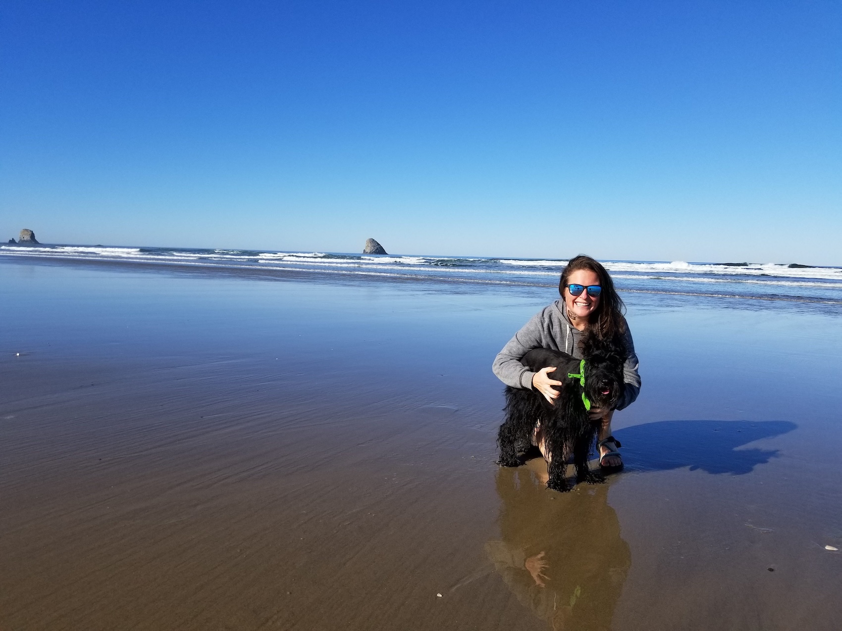 Emily Halnon and her dog Brutus, a pet who helped with mental health, pose at a beach