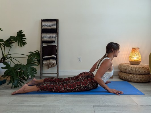 Yoga teacher demonstrating the right way to do cobra pose