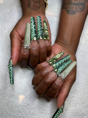 An image of Cynthia Ervio's long green, bedazzled nails in celebration of the Olympics