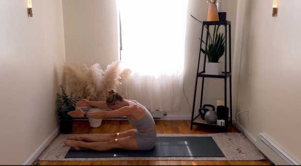 Personal trainer and Pilates instructor demonstrating roll-up