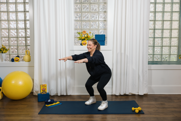 Shawn Johnson East demonstrating at-home workout squat