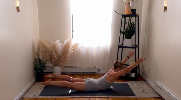 Personal trainer and Pilates instructor demonstrating spinal extension