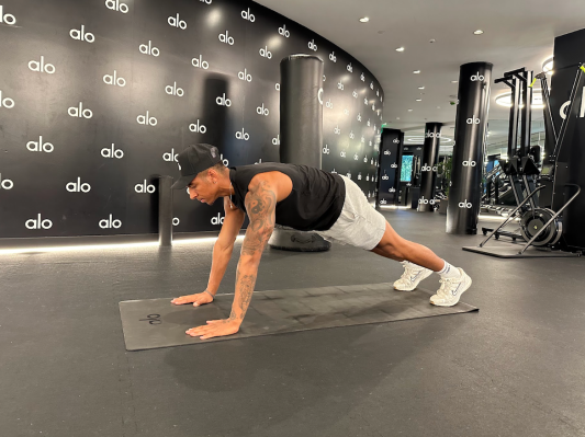 Personal trainer demonstrating high plank