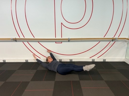 Personal trainer demonstrating hollow hold