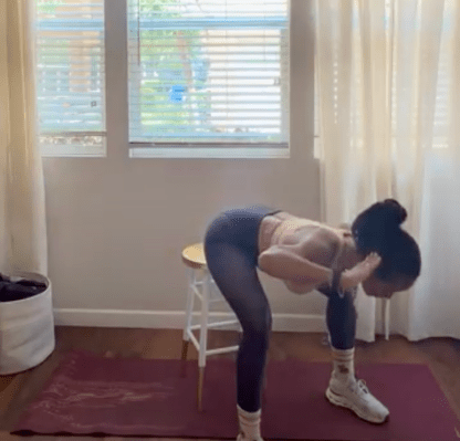 Personal trainer demonstrating seated good morning exercise