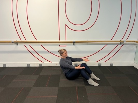 Personal trainer demonstrating a sit-up