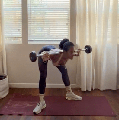 Personal trainer demonstrating sumo good morning exercise