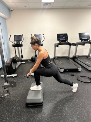 Personal trainer demonstrating cable step-up