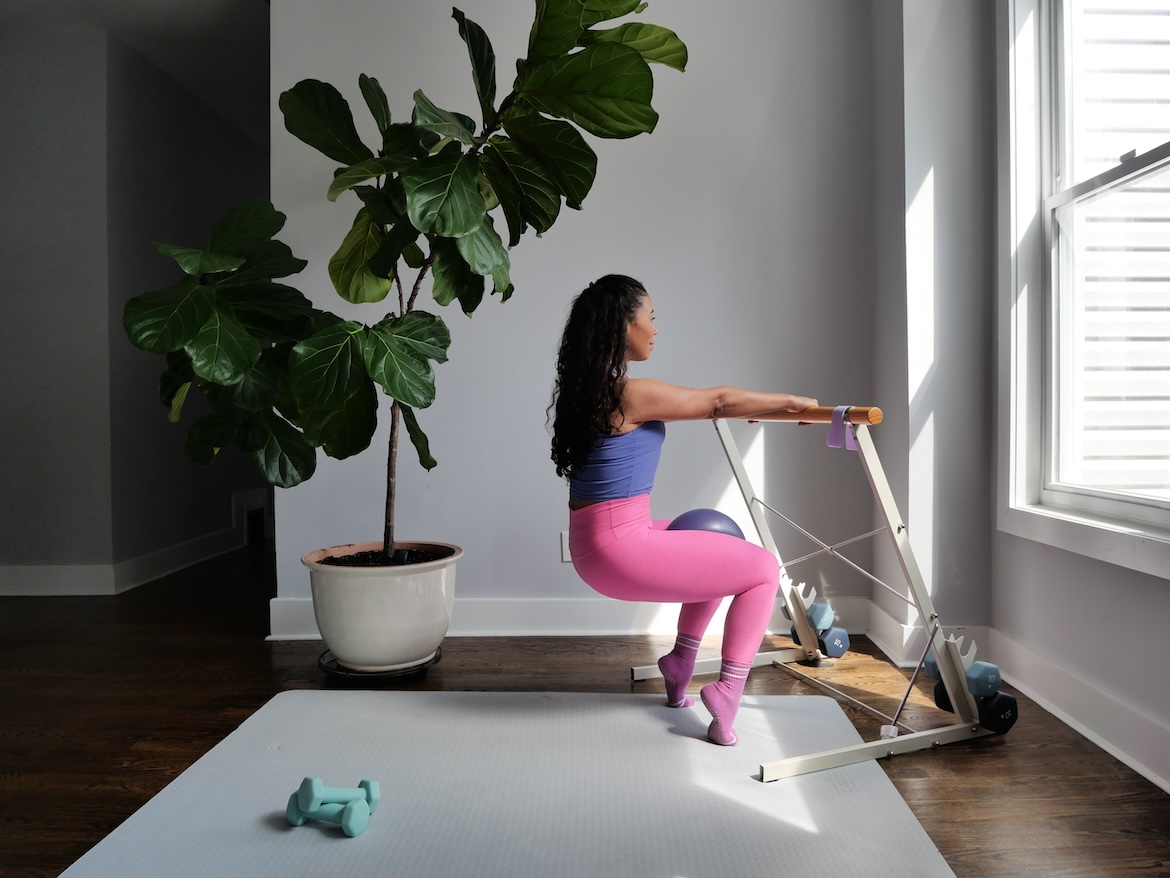 Barre instructor demonstrating chair position