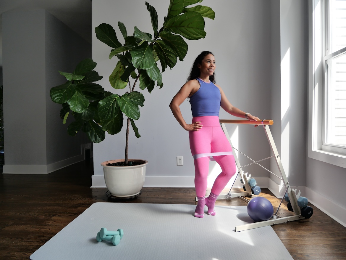 Barre instructor demonstrating first position 