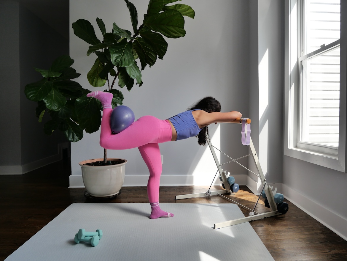 Barre instructor demonstrating foldover