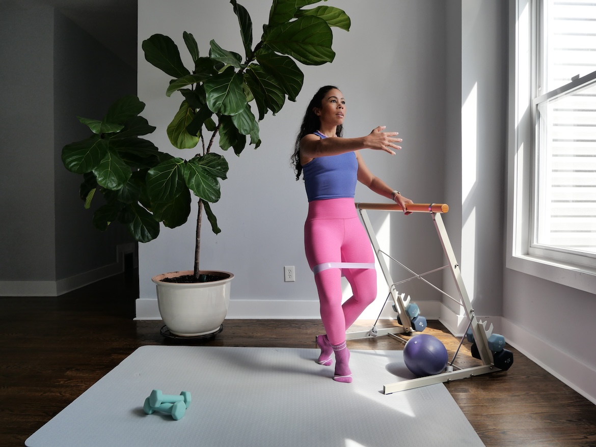 Barre instructor demonstrating fourth position