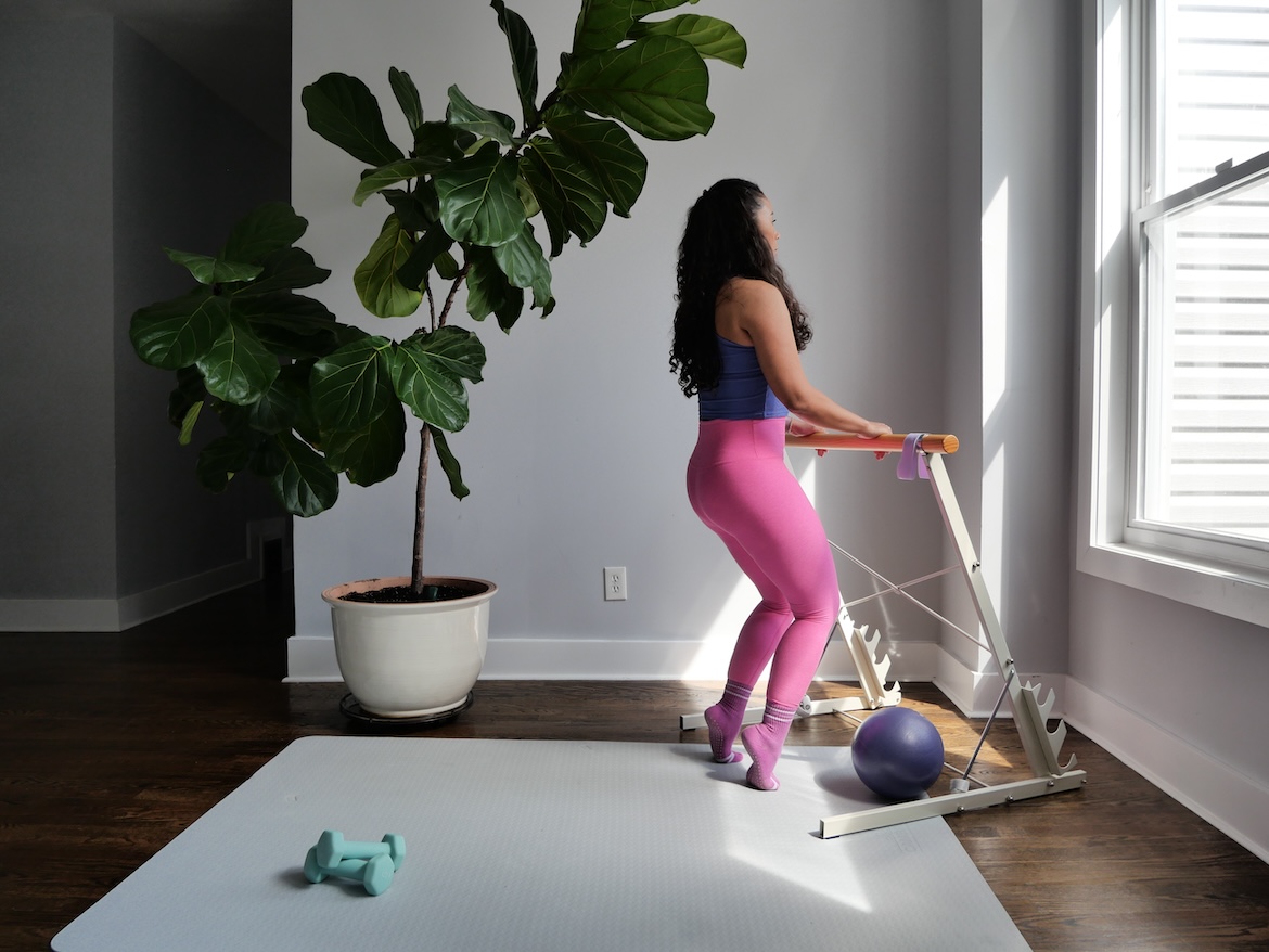 Barre instructor demonstrating hip-width parallel position