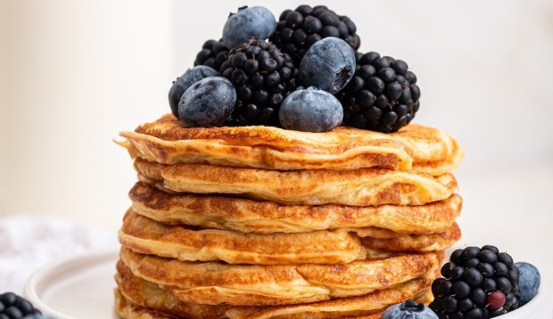 stack of cottage cheese pancakes with blueberries and blackberries on top