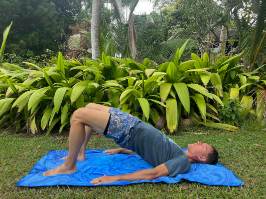 Physical therapist demonstrating glute bridge