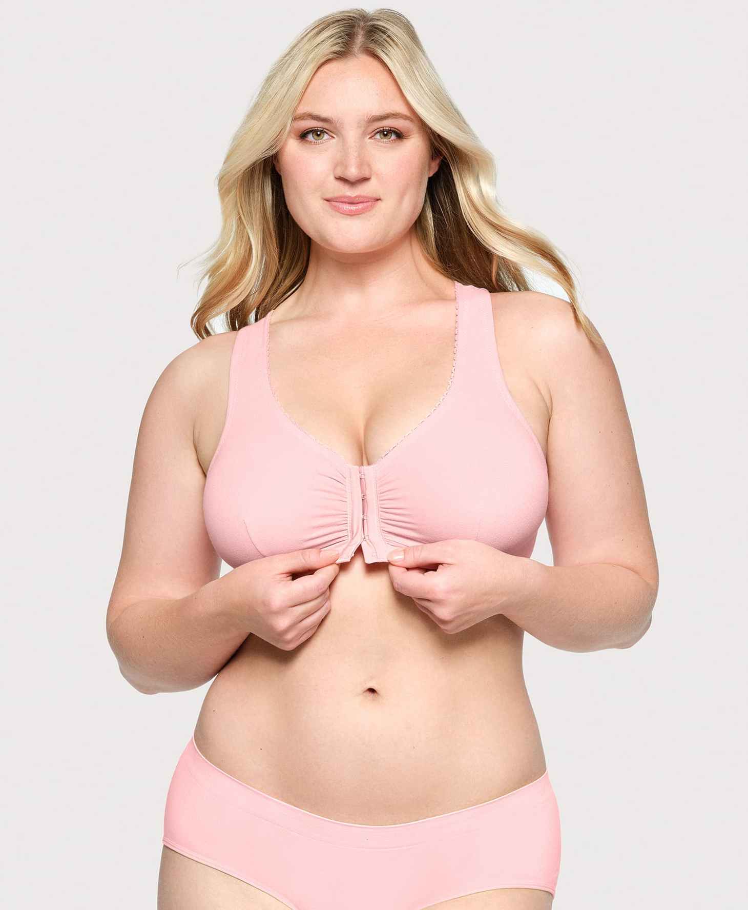 A curvy blonde woman wearing pink lingerie including a bra with a front opening